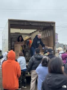 Residents of Tuktoyaktuk line up for cooling units with BBE and Promise for the North